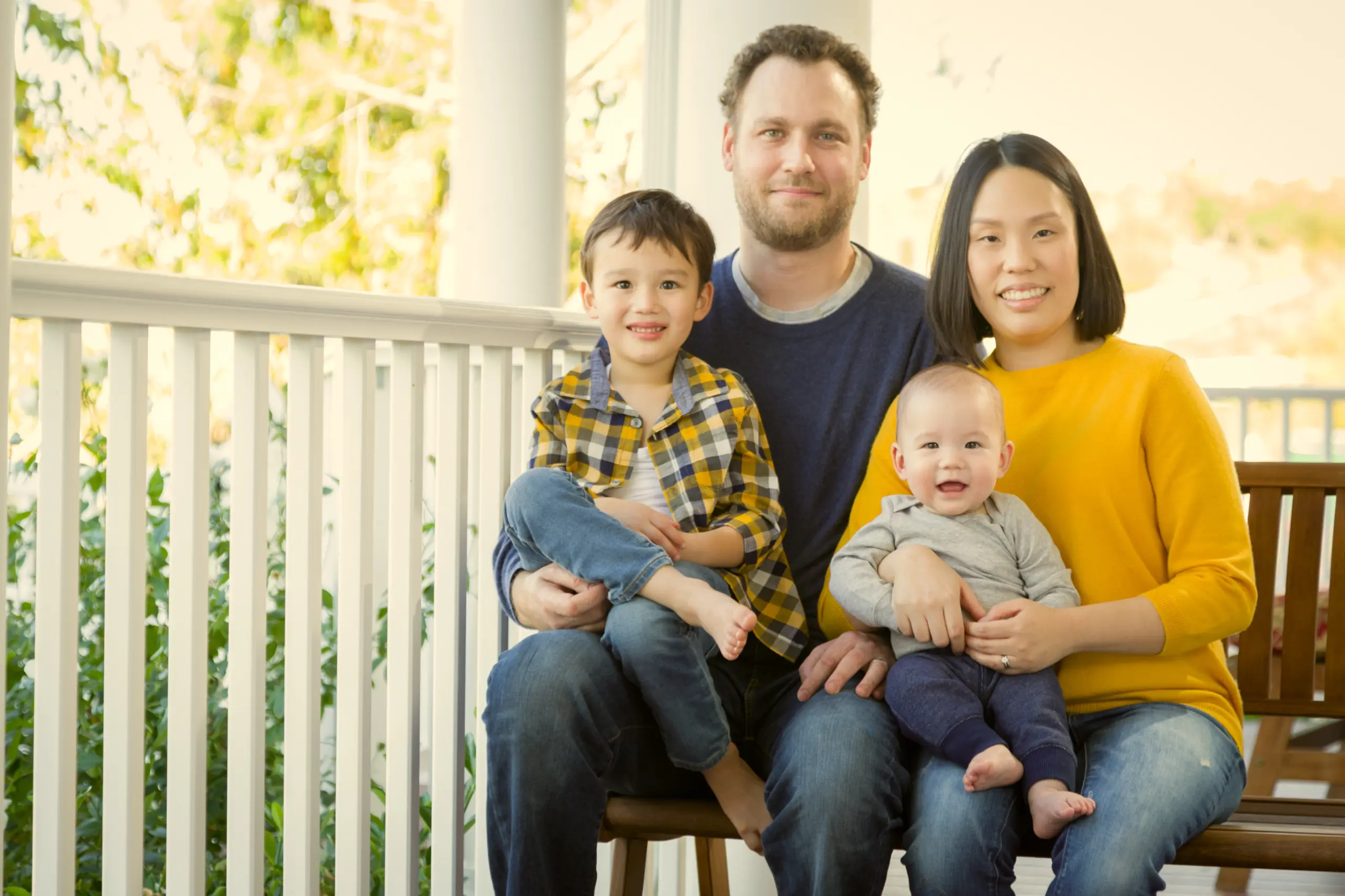 Happy family with nanny caring for children at home