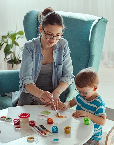 Experienced nanny engaging children in daily activities at home