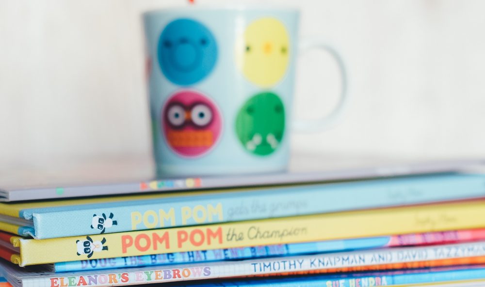 Child reading books in a safe and nurturing home environment