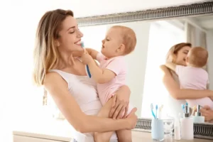 Mommy and baby brushing teeth